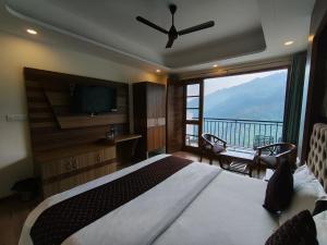 a bedroom with a large bed and a large window at Hotel Summer Hill in Chail