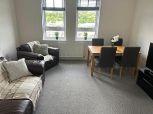 a living room with a couch and a table at Kilnhill in Hawick