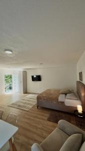 a bedroom with a bed and a flat screen tv at JazAzur in Lastva
