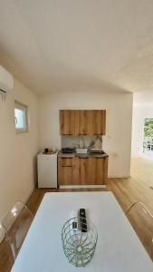 a kitchen with a white table in a room at JazAzur in Lastva