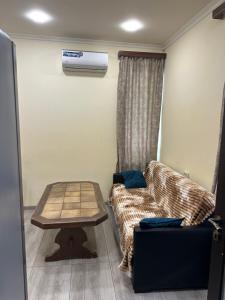 a living room with a couch and a table at Happy Holidays in Yerevan