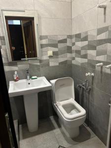 a bathroom with a toilet and a sink at Happy Holidays in Yerevan +2 photos