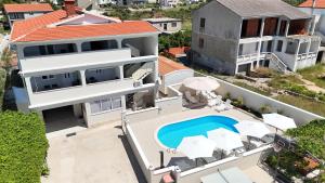 an aerial view of a house with a swimming pool at APARTMANI JAMAN in Vrsi