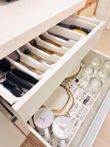 a drawer filled with wine bottles and glasses at Terracotta Azure in San Fernando
