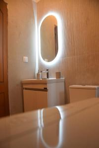 a bathroom with a sink and a mirror at Mellonia in Nikiti +44 photos