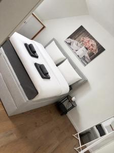 a bedroom with a bed with white sheets and pillows at Ferienwohnung Gut Lehmhof in Lehmrade