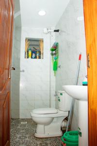 a bathroom with a toilet and a sink at Saagite Apartments in Ongata Rongai 