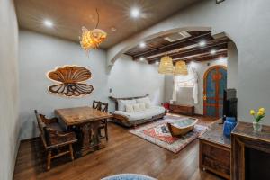 a living room with a table and a couch at Little Sun Homestay - Free Buggy Tour check-in Sunset Town in Phú Quốc