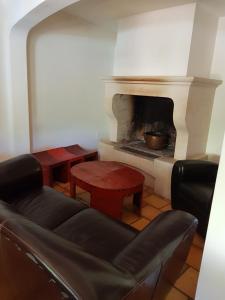 a living room with a couch and a fireplace at Maison les Salles-sur-Verdon in Les Salles-sur-Verdon +20 photos