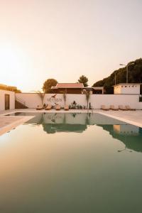 a pool of water in front of a building at Albatros Beach & Resort in Rrogozhinë