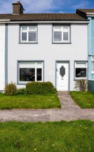 a white house with a driveway at Riverview House - Cahersiveen in Cahersiveen