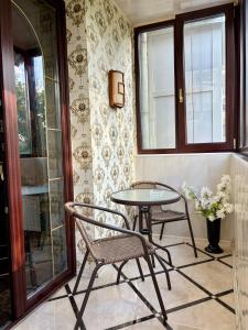 a patio with two chairs and a table and a window at Aladdin apartment in Kharkiv