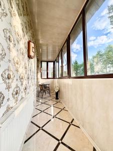 a hallway with windows and a tiled floor at Aladdin apartment in Kharkiv