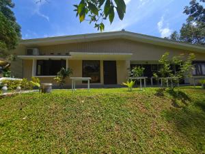 a house with a lawn in front of it at Melani Villa in Kandy +5 photos