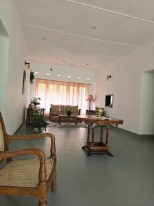 a large room with a table and chairs in it at Melani Villa in Kandy