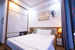 a bedroom with a white bed in a room at Villa Flamingo C607 in Thanh Hóa