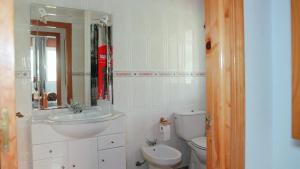 a bathroom with a sink and a toilet and a mirror at La Casuca in El Pelayo +49 photos