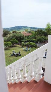 a balcony with a view of a table and chairs at La Casuca in El Pelayo