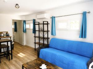 a living room with a blue couch and a table at Isa's Sweet Homes in Saint-Mitre-les-Remparts +28 photos