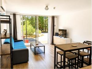 a living room with a couch and a table at Isa's Sweet Homes in Saint-Mitre-les-Remparts