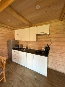 a kitchen with white cabinets and a counter top at Beauty House in Mykulychyn