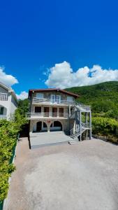 a large house with a staircase in front of it at JazAzur in Lastva