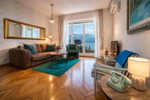 a living room with a couch and a table at Apartments Inspiration in Budva