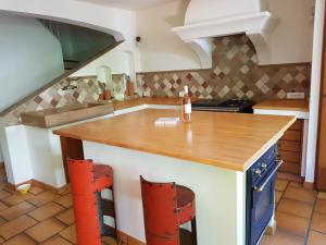 a kitchen with a wooden counter top in a room at Maison les Salles-sur-Verdon in Les Salles-sur-Verdon