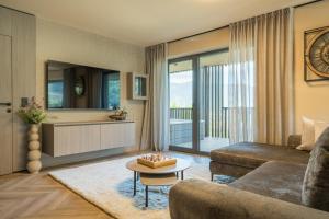 a living room with a couch and a table at Hotel Residence MaVie in Lagundo