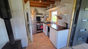 a small kitchen with a counter and a sink at Peeduland Cabin in Kohatu