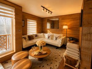 a living room with a couch and a table at Departamentos Exclusivos Termas de Chillán in Nevados de Chillan