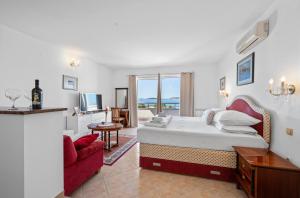 a bedroom with a large bed and a television at Villa Baron - Adriatic Sea View in Šibenik