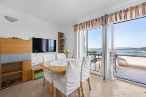 a dining room with a table and a view of the ocean at Villa Baron - Adriatic Sea View in Šibenik