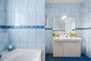 a bathroom with a white tub and a sink and a bath tub at Villa Baron - Adriatic Sea View in Šibenik +118 photos