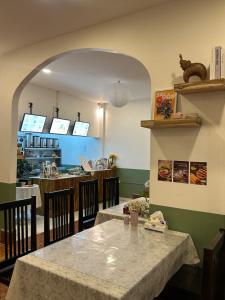 a dining room with a table and a counter at Homer House Hostel & Café in Vientiane +13 photos