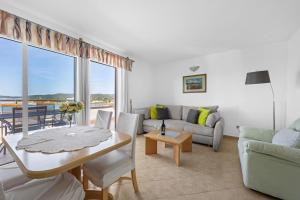 a living room with a table and a couch at Villa Baron - Adriatic Sea View in Šibenik