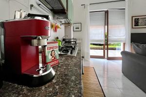 a kitchen with a red appliance on a counter at The Water Lodge in Omegna +7 photos