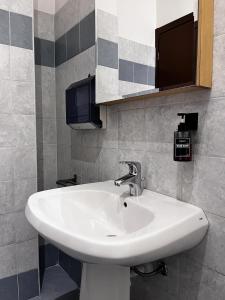 a bathroom with a white sink and a mirror at The Water Lodge in Omegna