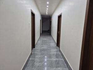 a hallway with two doors and a tile floor at Hotel VR Plaza in Etah