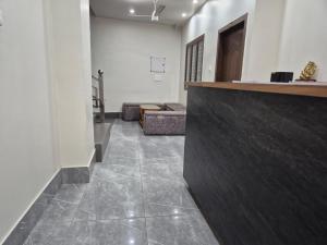 a lobby with a bar and a couch in a room at Hotel VR Plaza in Etah