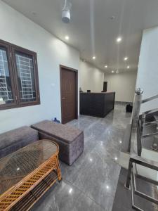 a living room with a couch and a table at Hotel VR Plaza in Etah +1 photo