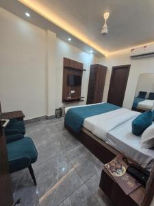 a bedroom with a large bed and a television at Hotel VR Plaza in Etah