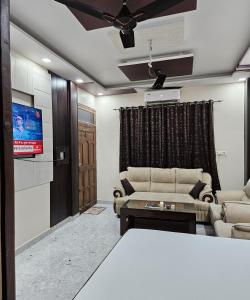 a living room with a couch and a tv at The Hotel Siddhi Residency near Ram Mandir in Ayodhya