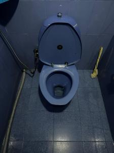 a bathroom with a blue toilet in a stall at Y Not Sonada in Sonāda +12 photos