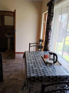 a dining room with a table and a window at Buffalo Street Cottages in Malelane