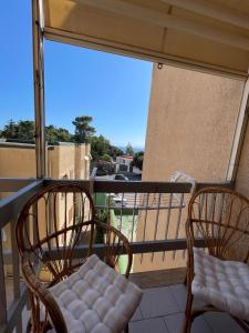 two chairs sitting on a balcony with a view at Mare Mio Talamone in Talamone