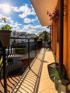 a balcony with a fence and a view of a building at Big Foot by MANGO Food&Bar in Karwia