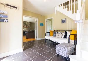 a living room with a couch and stairs at Winoma Lodge - Waterville in Waterville