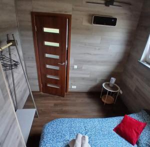 a room with a bed and a wooden door at Celmu Nams in Ventspils