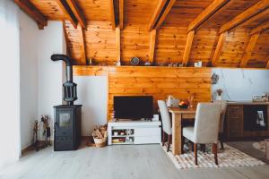 a living room with a desk and a wood stove at Etno Villa Popovic in Žabljak